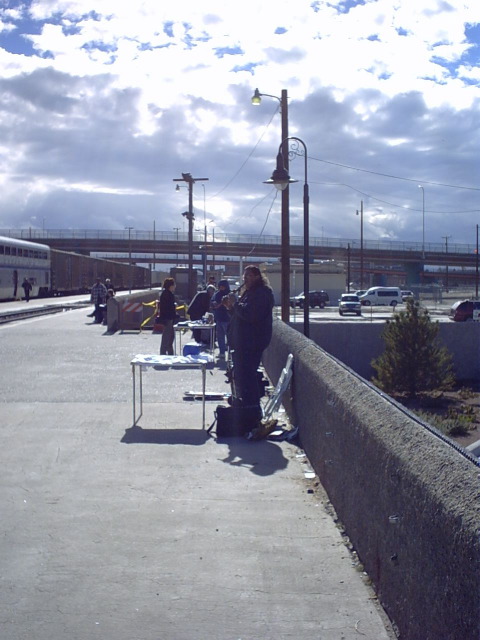 ABQ: flute player with wares for sale